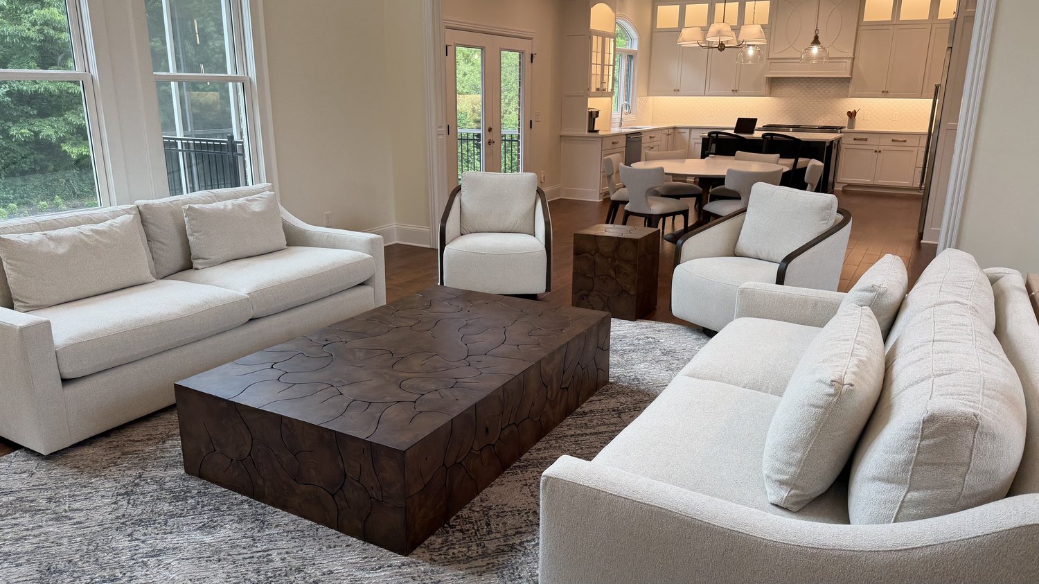 Open plan living and dining area after, with layered seating and a live edge coffee table