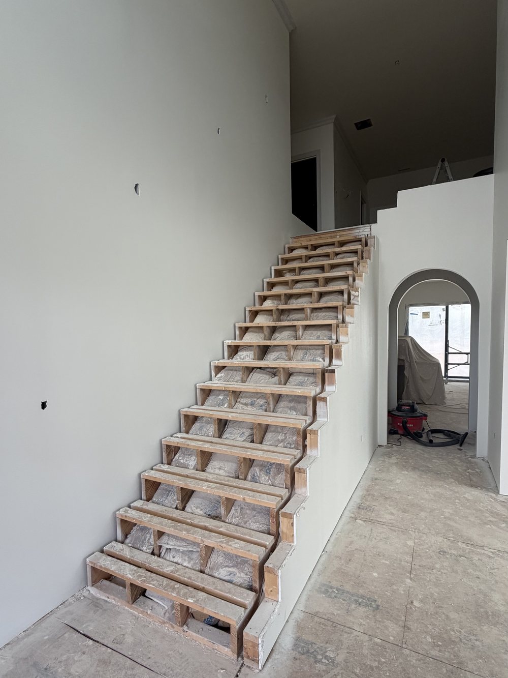 Staircase and two storey entry before the Nelson Home & Company transformation