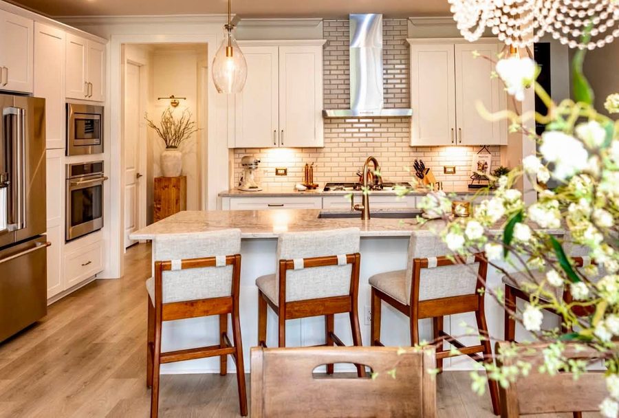 Kitchen with a plaster hood, subway tile backsplash and wood counter stools