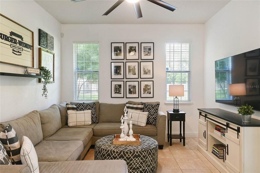 Family room with a sectional, framed gallery wall and built-in media cabinet
