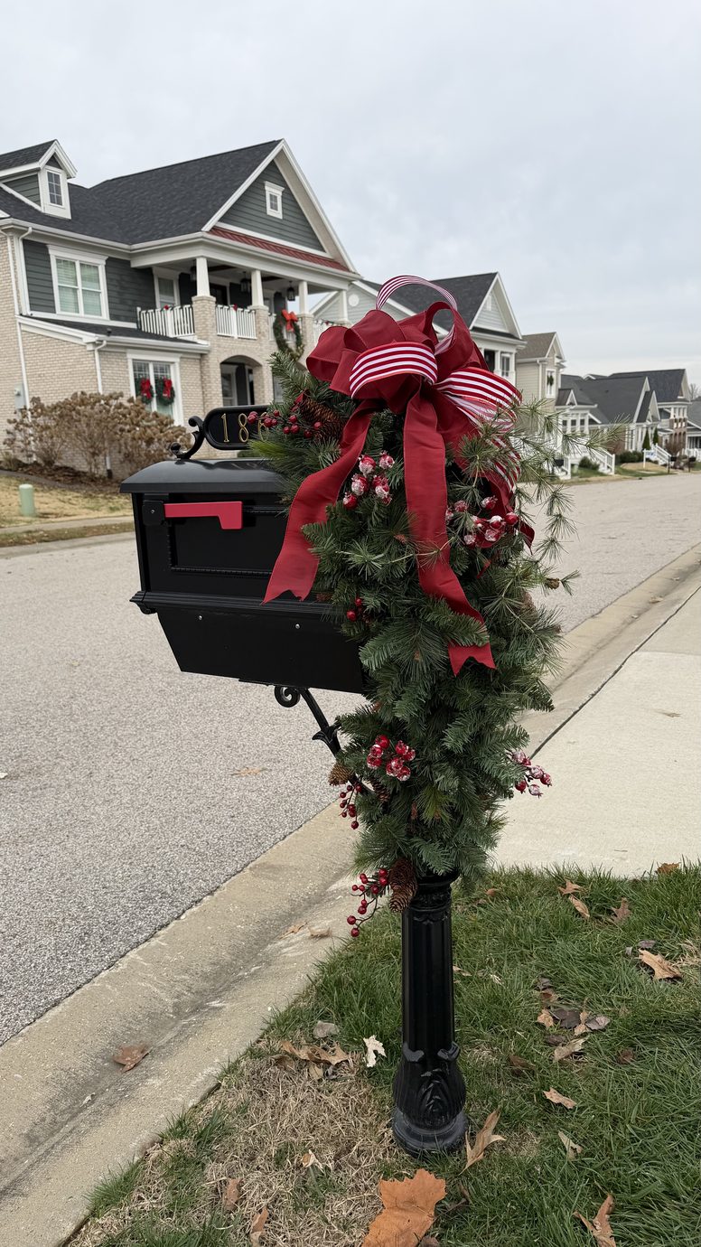 Mailbox dressed with cedar garland and ribbon for the holidays