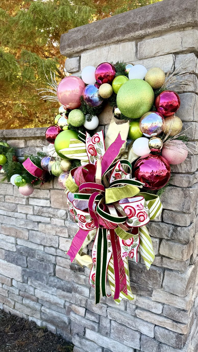 Seasonal wreath mounted on an exterior stone wall