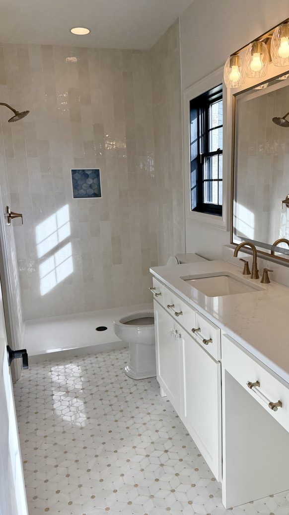 Ensuite bathroom with a tiled walk-in shower and marble topped vanity